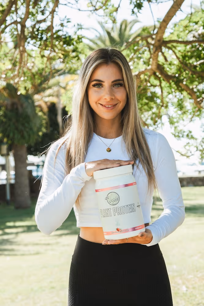 a photo of a lady holding a protein powder tub